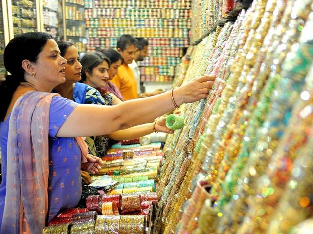 Customers inspect displays of bangles on sale in Amritsar on October 13, 2011. Bangles are in heavy demand ahead of the forthcoming Karva Chauth festival.