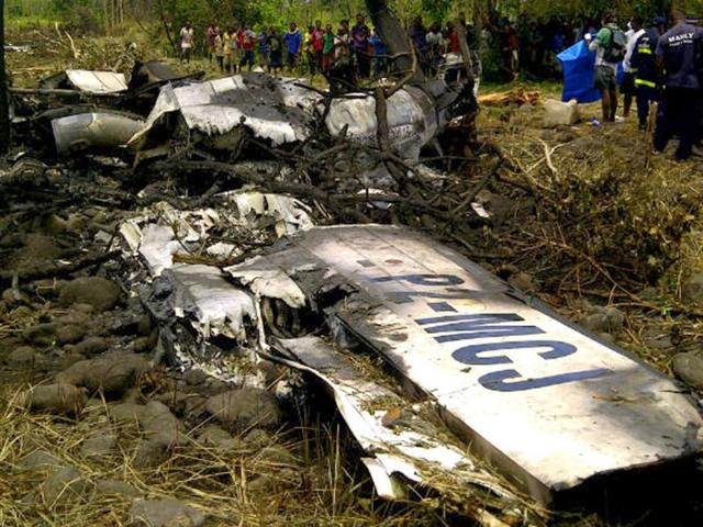 Locals gather at the crash site of an Airlines PNG Dash 8 plane near Madang in Papua New Guinea.