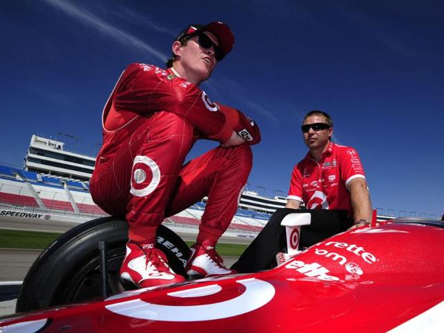 Scott Dixon of New Zealand driver of the #9 Target Chip Ganassi Racing Dallara Honda chats with team member Blair Julian also of New Zealand during practice for the IZOD IndyCar Series World Championship at the Las Vegas Motor Speedway in Las Vegas, Nevada. Scott Dixon of New Zealand driver of the #9 Target Chip Ganassi Racing Dallara Honda chats with team member Blair Julian also of New Zealand during practice for the IZOD IndyCar Series World Championship at the Las Vegas Motor Speedway in Las Vegas, Nevada.