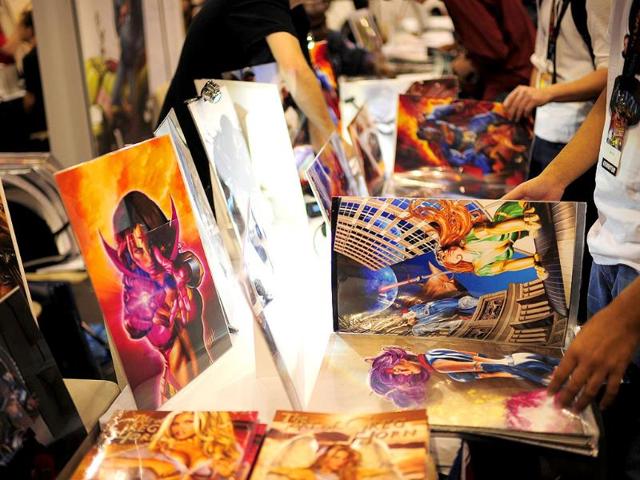People check out artwork displayed at the New York Comic Con, the US East Coast's largest popular culture convention. (AFP)