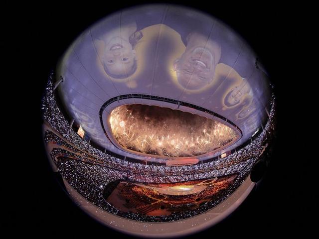 Faces are projected on the roof as fireworks explode over Omnilife Stadium in this fisheye lens view during the opening ceremony of the Pan American Games in Guadalajara.