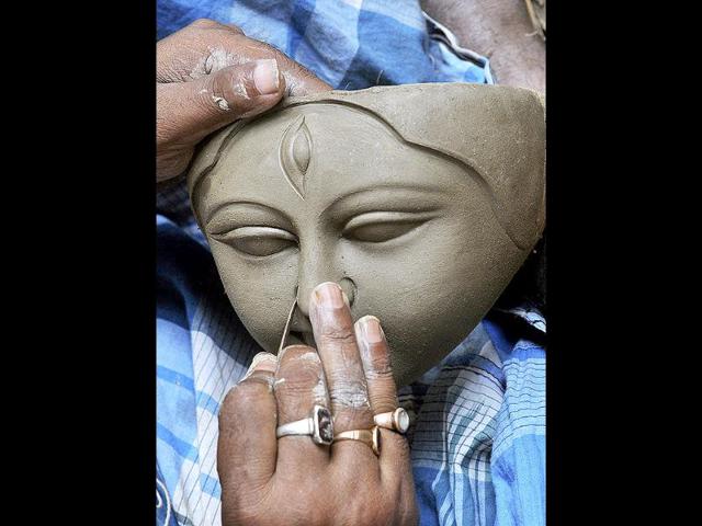 An Indian artisan works on an idol of Hindu Goddess Kali in preparation for Diwali, the Hindu festival of lights, in Agartala.