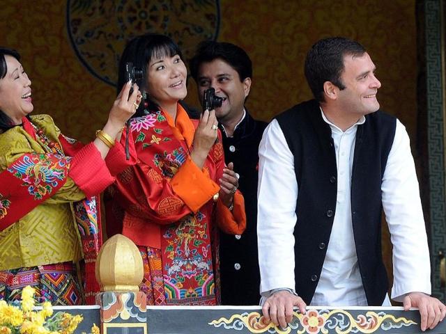 MP Rahul Gandhi and Jyotiraditya Madhavrao Scindia react as queens of former Bhutan King Jigme Sinagye Wangchuk take photographs during a ceremony for the newly wed Bhutanese couple at the main stadium in Thimphu.