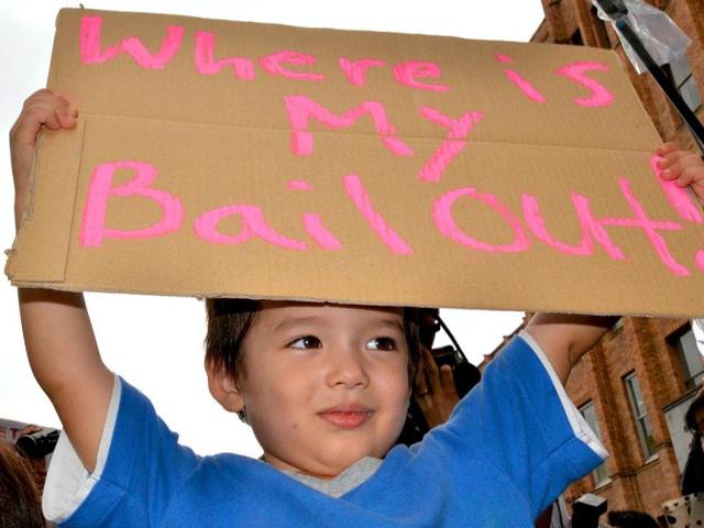A child holds up a placard during a worldwide protest inspired by the Occupy Wall Street protest in Tokyo.