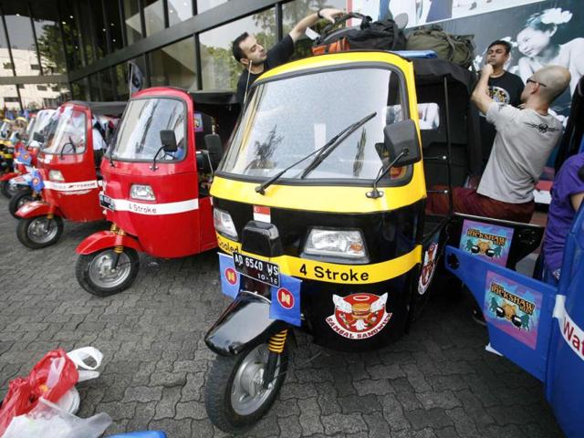 Participants of the ASEAN Rickshaws Run from Singapore prepare their auto-rickshaw at the ASEAN Secretariat building in Jakarta.