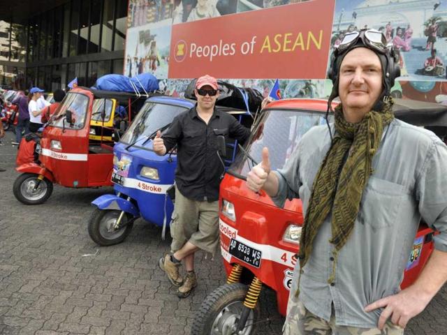 Singapore residents Dan Fidock (R) and Daniel Vanhaeff (L) pose in front of their auto-rickshaw during the send-off ceremony in Jakarta.