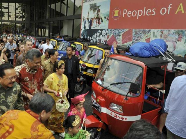 Association of Southeast Asian Nations (ASEAN) Secretary General Surin Pitsuwan (2L brown shirt) accompanied by Jakarta City Governor Fauzi Bowo (L green shirt) inspects the 28 petrol fueled auto-rickshaws that will be used in the 3,000-kilometre ASEAN Rickshaw Run at the place where the journey starts in Jakarta.