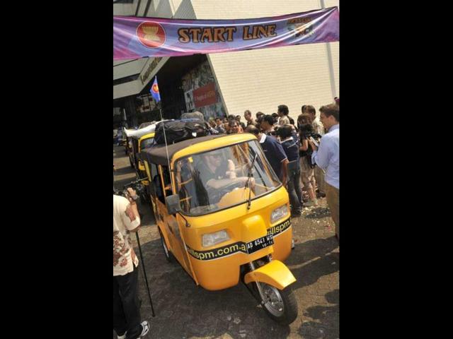 An auto-rickshaw is driven from the startline during the send-off ceremony in Jakarta.