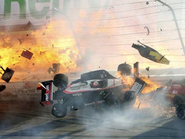 The race car of driver Will Power hits the wall as flames from British driver Dan Wheldon's car burst (at left) during the IZOD IndyCar World Championship race at the Las Vegas Motor Speedway in Las Vegas, Nevada.