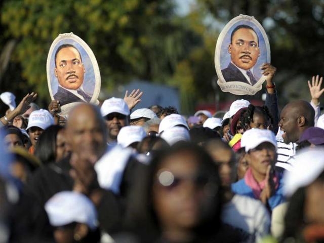 Portraits of Martin Luther King, Jr are held aloft during the dedication of the Martin Luther King Jr Memorial in Washington.
