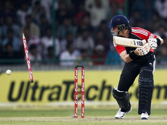 England's Graeme Swann looks back at the wickets as he is bowled by Vinay Kumar during their second one-day international cricket match in New Delhi.