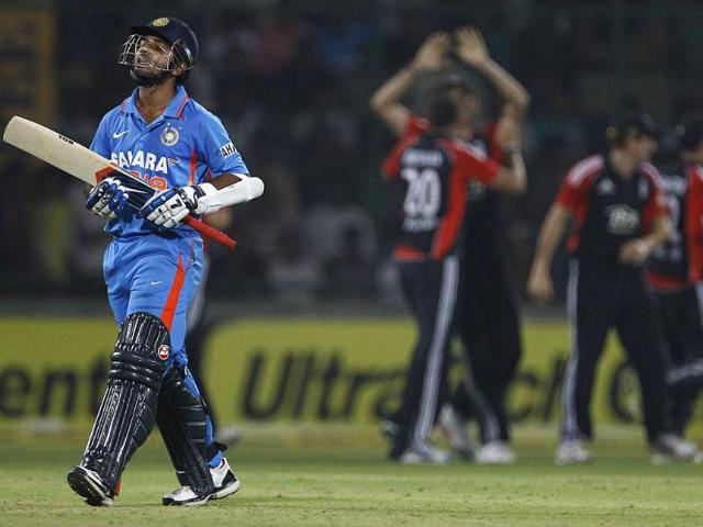 Ajinkya Rahane reacts as he leaves the ground after losing his wicket during their second one-day international cricket match against England in New Delhi.