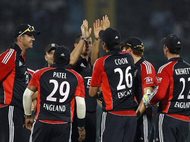 England's bowler Tim Bresnan celebrates with teammates the dismissal of Parthiv Patel, not seen, during their second one-day international cricket match in New Delhi.