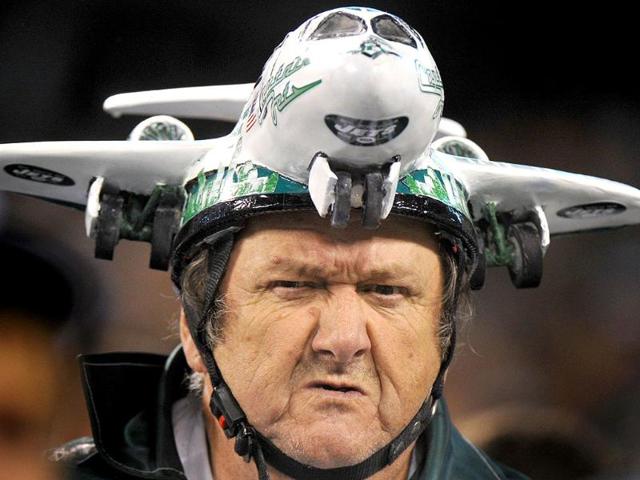 A New York Jets fan wears a hat shaped in the form of a jet in the stands during the NFL football game against the Miami Dolphins in East Rutherford, New Jersey.