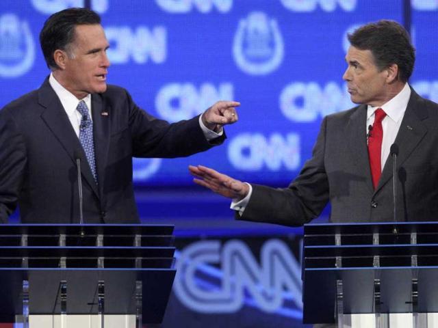 GOP presidential candidates former Massachusetts governor Mitt Romney (L) and Texas governor Rick Perry debate illegal immigration as they take part in the CNN Western Republican debate in Las Vegas.