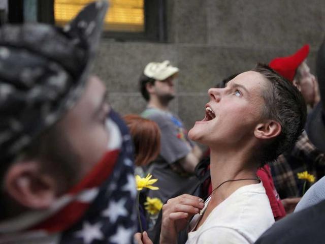 A member of the Occupy Wall Street movement chants outside the office of Manhattan District Attorney Cyrus R Vance Jr in New York.
