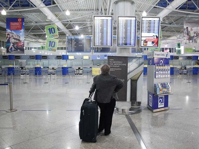 A passenger looks for information in the departure hall of Athens' International airport during a 48 hour-general strike in Athens.