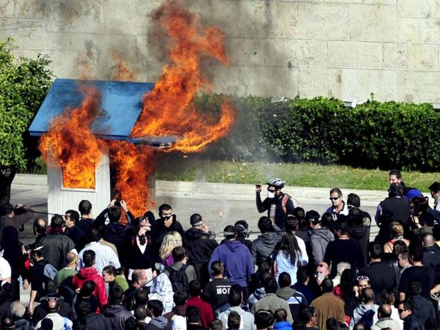 Protesters burn a guard box in front of the Greek parliament in Athens.