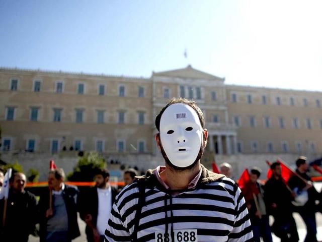 A demonstrator stands in front of the Greek parliament in Athens as a two-day general strike began against a new austerity bill.