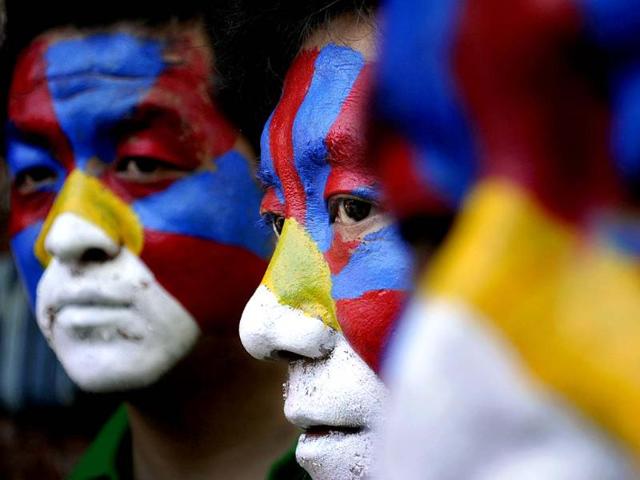 Tibetan exiles, with faces painted in the Tibetan flag colors, participate in a rally to express solidarity with the plight of the people in Tibet, in New Delhi.