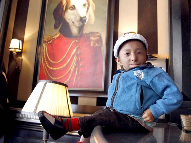 Nepalese Guinness World Record holder Khagendra Thapa Magar, 19, the second world's smallest man with 67 cm (26 inches), poses in a French cafe in Paris.