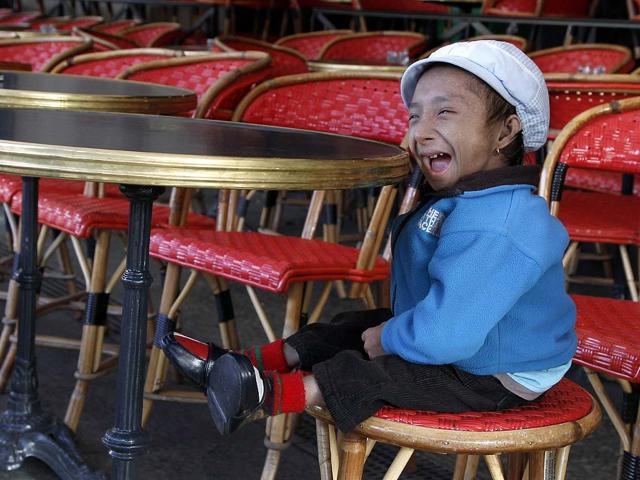 Nepalese Guinness World Record holder Khagendra Thapa Magar, 19, the second world's smallest man with 67 cm (26 inches), poses in a French cafe in Paris.
