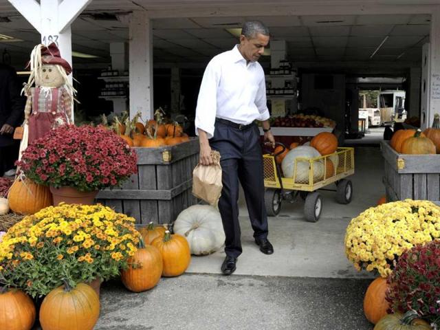 President Barack Obama wheels out his pumpkins at Wood's Orchard in Hampton. (AP)