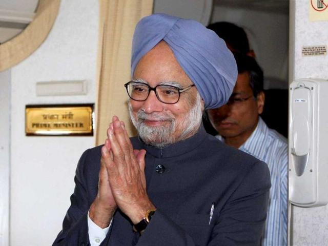 Prime Minister Manmohan Singh arrives for onboard press conference after completing of his Pretoria, South Africa tour. (PTI)