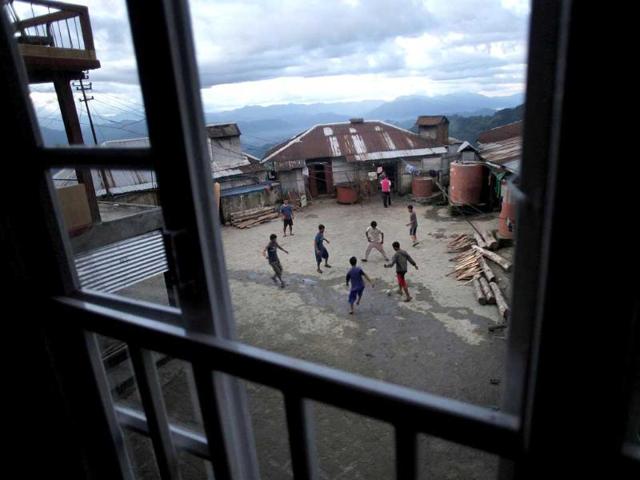 Ziona's son and grandsons play soccer inside their home in Baktawng village in Mizoram. (Reuters)