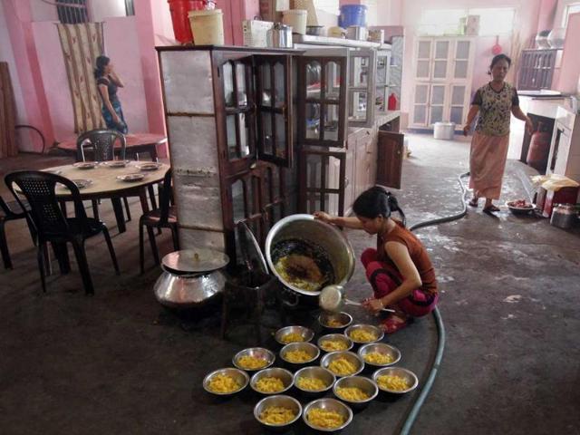 A wife of Ziona, prepares breakfast at their residence in Baktawng village in Mizoram. (Reuters)