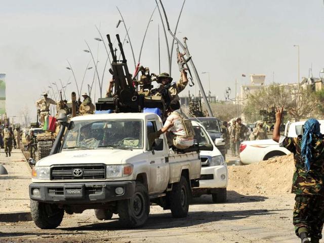 Anti-Gaddafi fighters celebrate the fall of Sirte. (Reuters/Esam Al-Fetori)