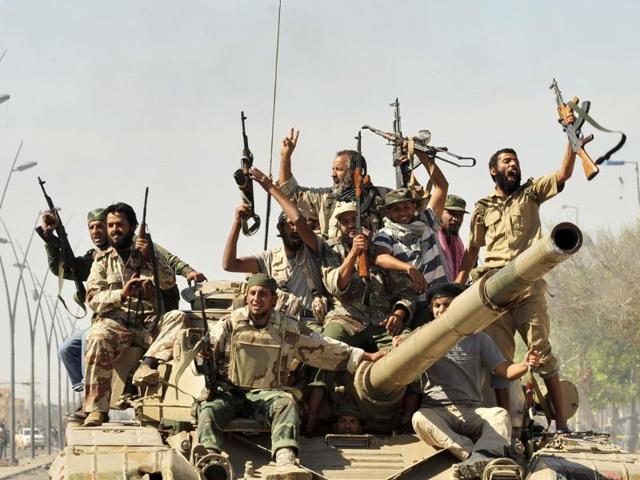 Anti-Gaddafi fighters celebrate the fall of Sirte in the town. (Reuters/Esam Al-Fetori)