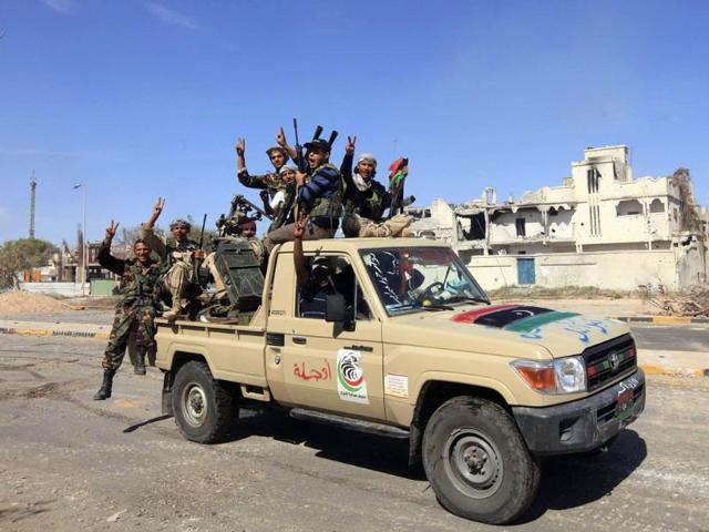 Anti-Gaddafi fighters celebrate the fall of Sirte. (Reuters/Esam Al-Fetori)