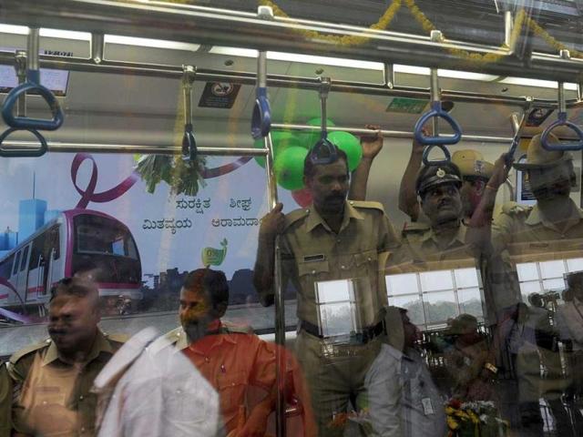 Passengers and police ride in the Bangalore Metro Rail Corporation's Namma metro during its inaugural run in Bangalore.
