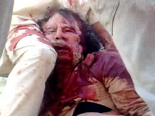 An image captured off a cellular phone camera shows the arrest of Libya's strongman Muammar Gaddafi in Sirte.