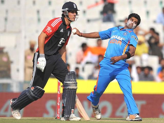 Vinay Kumar bowls as England cricket team captain Alastair Cook looks on during the third One day International at The Punjab Cricket Association (PCA) stadium in Mohali.