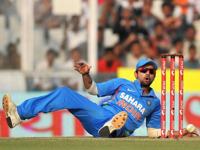 Virat Kohli attempts to run out England batsman Jonathan Trott during the third one day international cricket match between India and England at The Punjab Cricket Association (PCA) Stadium.