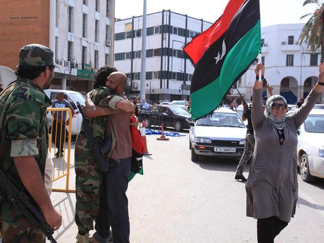 Libyan National Transitional Council (NTC) fighters are congratulated during celebrations in the streets of Tripoli.