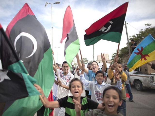 Libyan children waving National Transitional Council (NTC) flags celebrate in the streets of Tripoli.