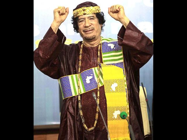 Libya's leader Muammar Gaddafi gestures as he attends the Second Forum for Kings, Sultans, Princes, Sheikhs and Mayors of Africa in Tripoli. (Files)