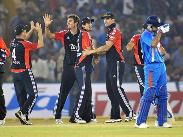 England bowler Steven Finn (C) celebrates with teammates after he dismissed Indian batsman Ajinkya Rahane during the third one day international cricket match between India and England at The Punjab Cricket Association (PCA) Stadium in Mohali.