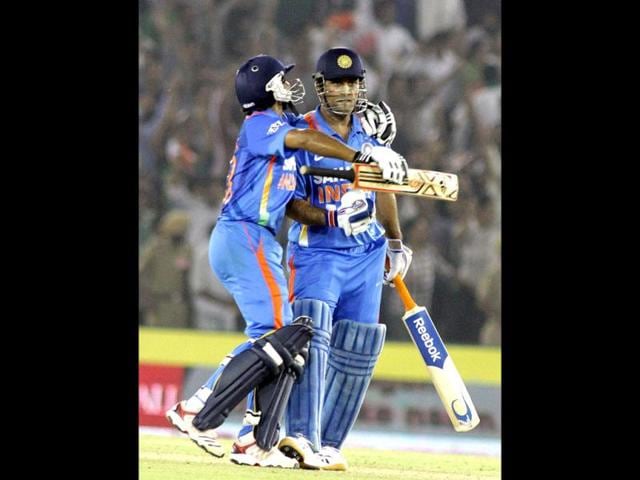 Indian team Captain MS Dhoni and Ravinder Jadeja celebrating the victory after they won the third ODI series between India Vs England at PCA Stadium in Mohali by HT Photographer Rajnish Katyal.