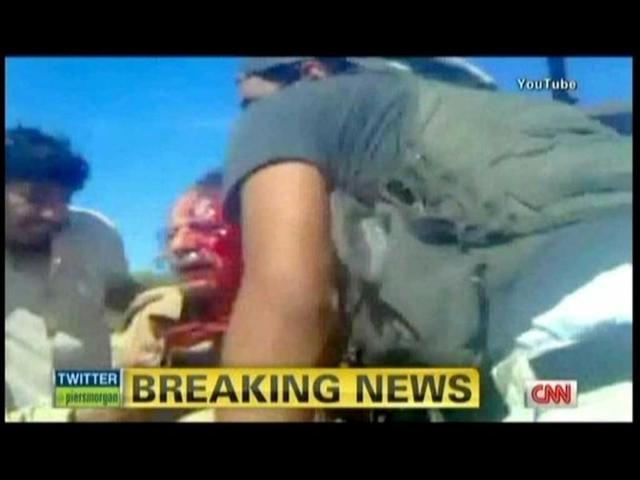In this TV grab from YouTube courtesy CNN, Muammar Gaddafi is seen moments after he was captured by Libyan rebel forces in his hometown Sirte. (AFP)