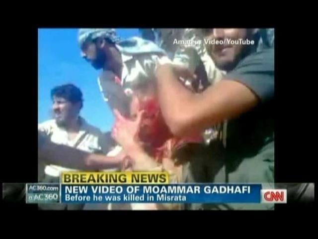Muammar Gaddafi is seen in the amateur TV grab from YouTube courtesy CNN, covered in blood moments after he was captured by Libyan rebel forces in his hometown Sirte. (AFP)