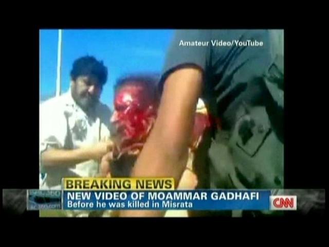 In this TV grab from YouTube courtesy CNN, Muammar Gaddafi is seen covered in blood moments after he was captured by Libyan rebel forces in his hometown Sirte. (AFP)