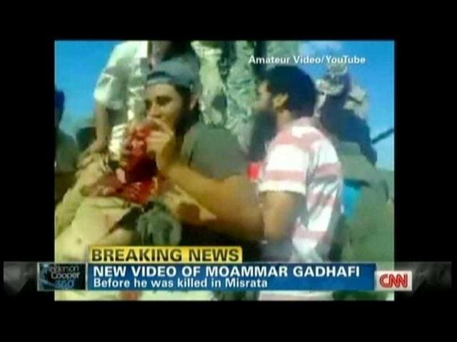 Libyan rebels are seen holding on to Muammar Gaddafi moments after he was captured. TV grab from YouTube courtesy CNN (AFP)