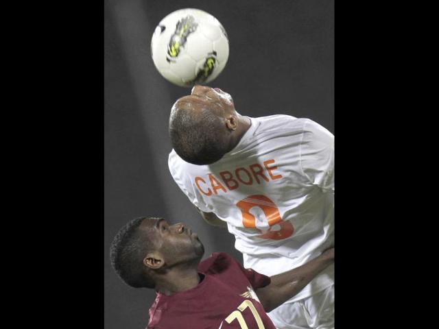 ElJaish's Nayef Al-Khater (L) fights for the ball with Umm Salal Cabore during their Qatar Stars League soccer match in Doha.