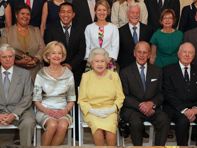 Britain's Queen Elizabeth II, sitting at center, and her husband the Duke of Edinburgh, second right, Governor-General Quentin Bryce, second left, with guests who were invited to a lunch hosted by Bryce at Government House in Canberra, Australia, pose for a group photo.