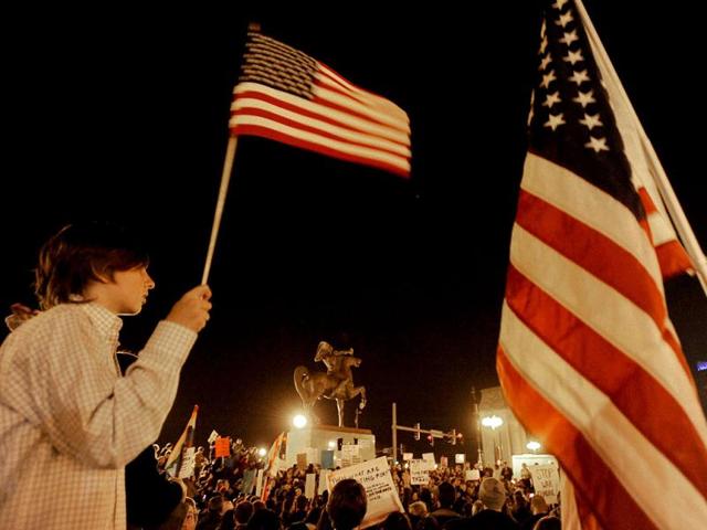 Protesters gather at night in Grant Park during an Occupy Chicago march and protes in Chicago. Protesters led a slow march from Chicago's financial district Saturday, taking more than 45 minutes to reach the park. Along the way, police on horses blocked marchers from walking on the street on Michigan Avenue, leaving them with just the sidewalks to occupy.