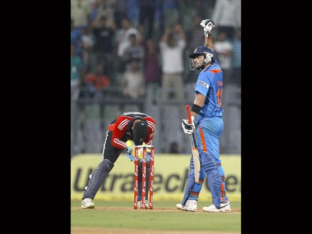 Virat Kohli, right, and England's wicketkeeper Craig Kieswetter, left, react after India won the the fourth one-day international cricket match in Mumbai.
